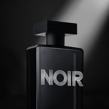 Load image into Gallery viewer, Angled view of Noir Homme cologne with spotlight accent