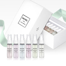 Load image into Gallery viewer, Six 4ml Michel Germain perfume vials displayed upright, including French Pear and Queen’s Lilac