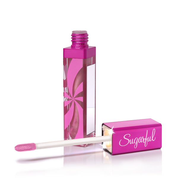 A pink tube of Sugarful lip gloss with an application mirror and light in the applicator tube, displaying a clear, glossy finish lip gloss.