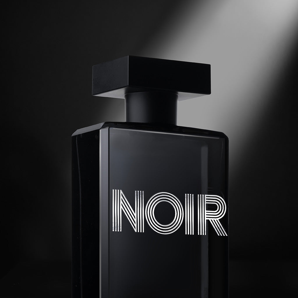 Angled view of Noir Homme cologne with spotlight accent