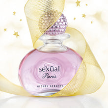 Load image into Gallery viewer, Perfume bottle labeled &#39;Sexual Paris&#39; by Michel Germain with a gold ribbon on a light background
