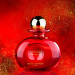 Bold red Sexual Oud Rouge perfume bottle on glittering background for Rouge Sex