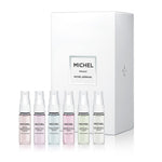 Top-down view of six Michel Germain 4ml perfume vials from the Discovery Set, featuring French Pear and Queen’s Lilac
