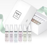 Six 4ml Michel Germain perfume vials displayed upright, including French Pear and Queen’s Lilac