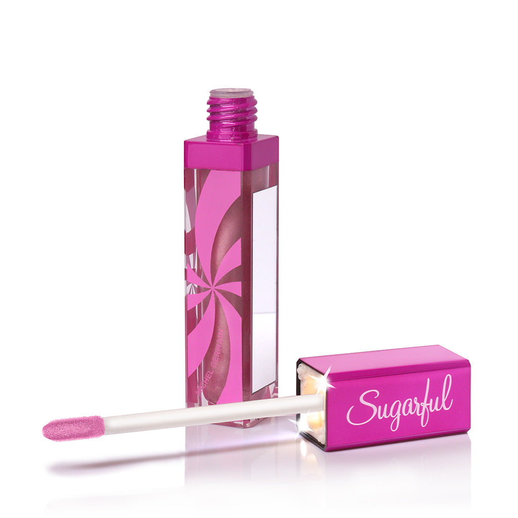 A pink tube of Sugarful lip gloss with an application mirror and light in the applicator tube, displaying a clear, glossy finish lip gloss.